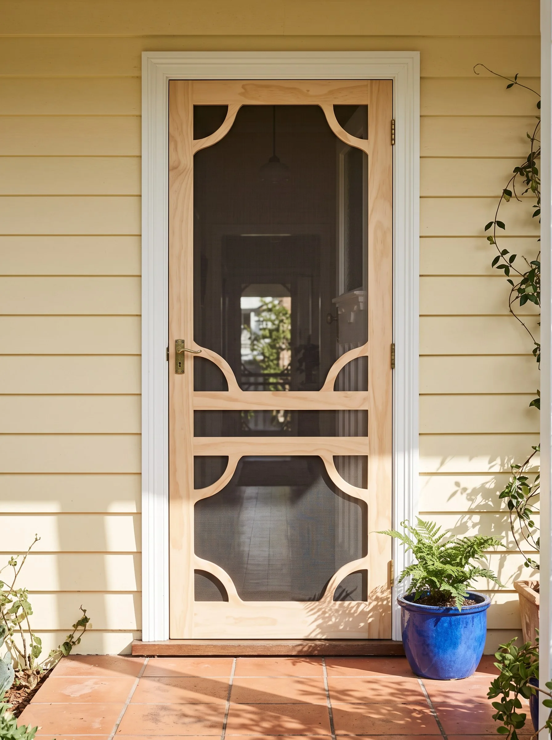 AI-styled concept of Karem’s SD3 natural timber screen door in a colourful Australian cottage entrance